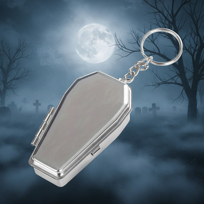 Silver coffin-shaped keychain on a white background